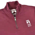 Close up on collar burgundy quarter zip with UCL 200 logo on chest 